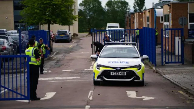 Police stand at the school gates