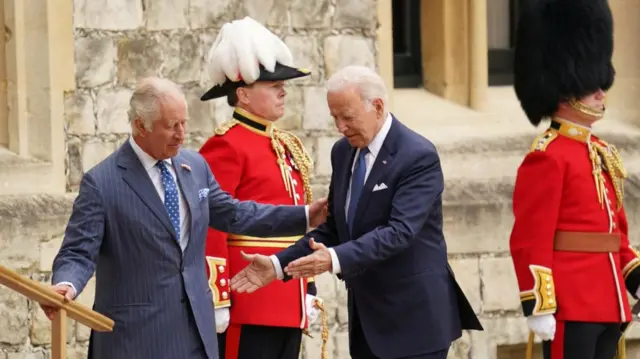 Joe Biden arrives at Windsor Castle and is welcomed by King Charles