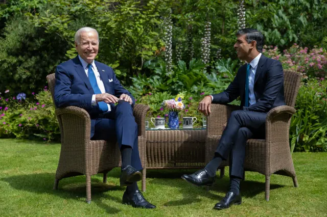 Biden and Sunak having tea in the garden