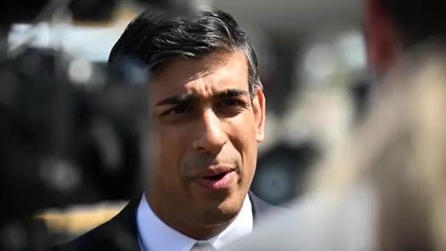 Prime Minister Rishi Sunak speaks to the media after landing in Vilnius for the Nato summit