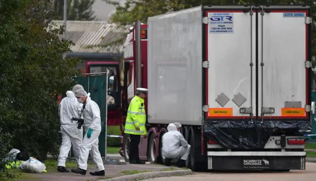 Forensics teams inspect the lorry in Grays, Essex