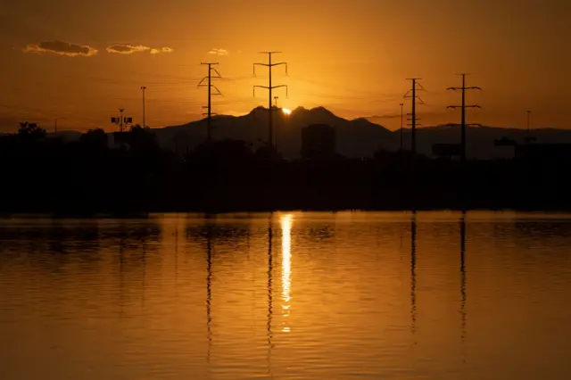 The sun rises at Tempe Town Lake on July 12, 2023 in Tempe, Arizona. Tuesday marked the Phoenix-area's 12th consecutive day of temperatures reaching over 110 degrees, as a record-breaking heat wave continues across the Southwest.