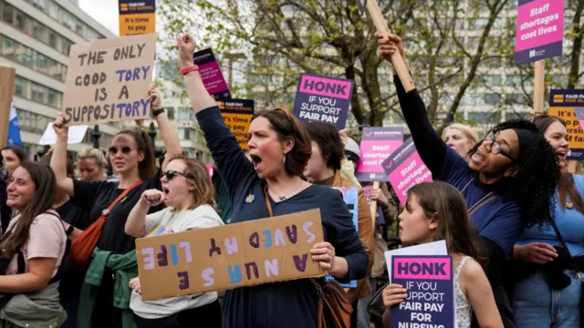 NHS workers attend a strike