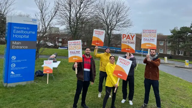 Doctors holding signs