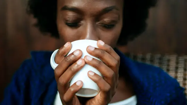 Woman's hands holding cup of coffee