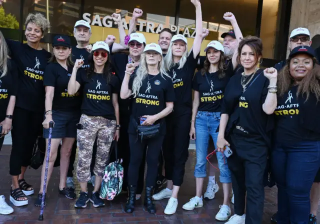 Members of SAG gather Friday morning to head to the studios and protest