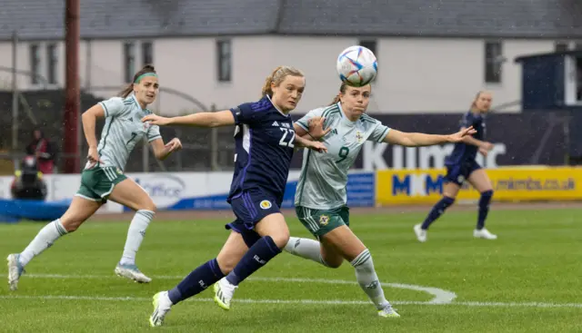 Erin Cuthbert battles for possession