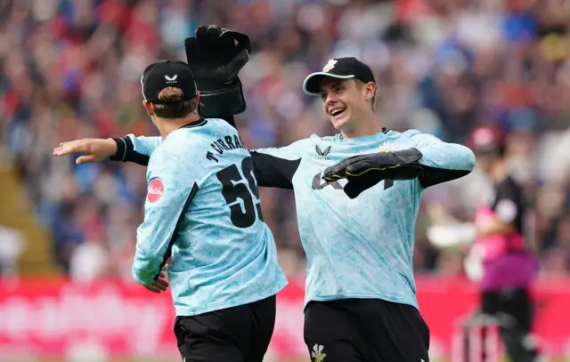 Surrey celebrate Tom Curran's catch to dismiss Craig Overton