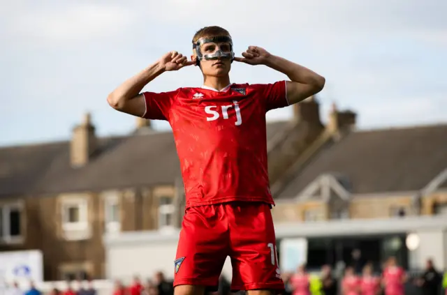 Matthew Todd celebrates after scoring his penalty