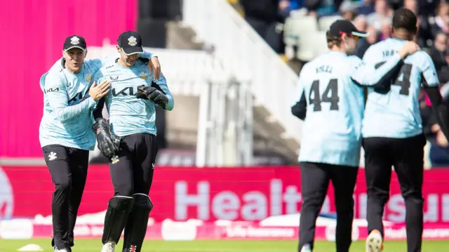 Surrey celebrate Jamie Smith's catch to dismiss Lewis Gregory