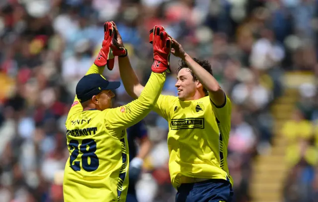 John Turner of Hampshire celebrates taking the wicket of Paul Walter of Essex with Ben McDermott