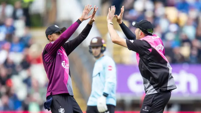 Somerset's Craig Overton celebrates with Ish Sodhi after catching his brother Jamie Overton.