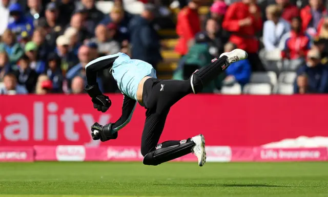 Surrey wicketkeeper Jamie Smith takes a diving catch