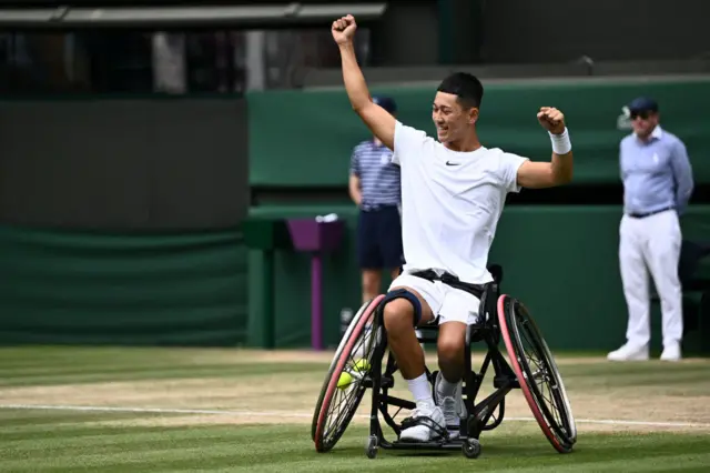 Tokito Oda raises his arms in the air to celebrate winning the Wimbledon wheelchair singles title