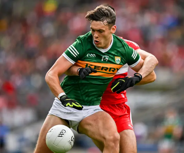 David Clifford of Kerry is tackled by Christopher McKaigue of Derry