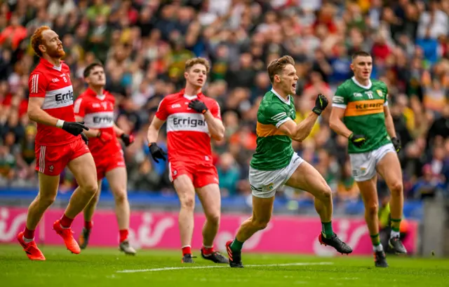 Derry players react as Gavin White of Kerry celebrates