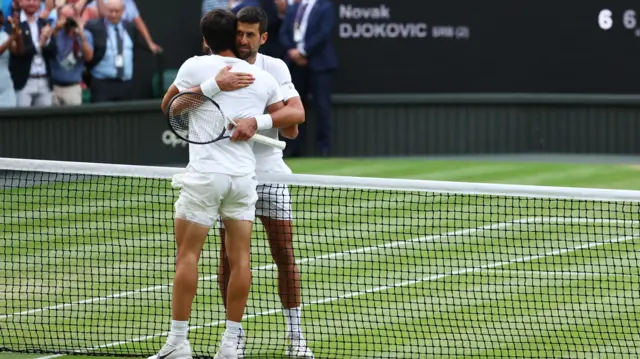 Djokovic and Alcaraz embrace at the net