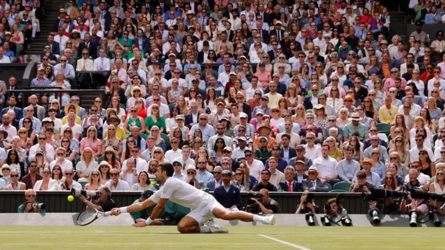 Novak Djokovic dives for a ball