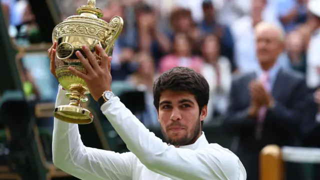 Carlos Alcaraz lifts the Wimbledon trophy