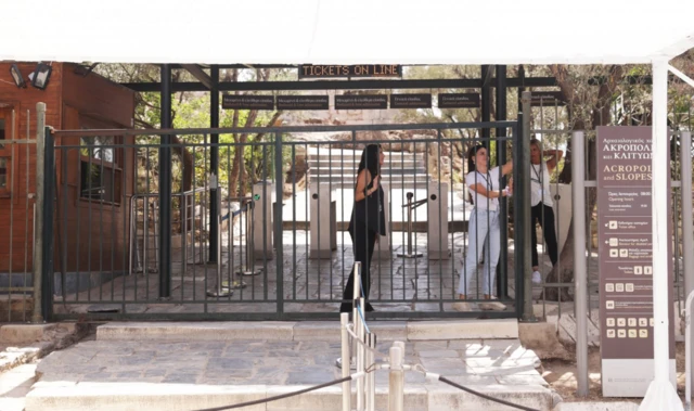 Acropolis workers close the entrance to the Acropolis site