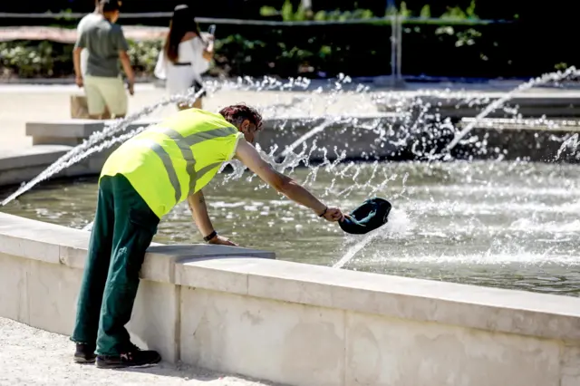 A man cools off in a fountain in Milan