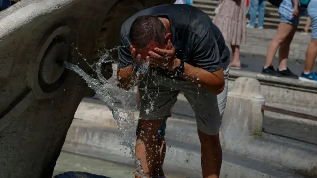 A man splashing his face with water in Rome