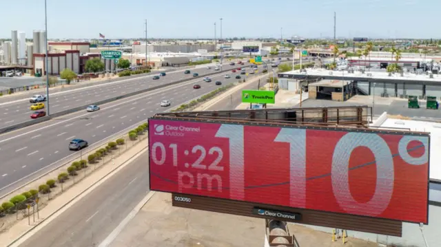 In an aerial view, a billboard displays the temperature that was forecast to reach 115 degrees Fahrenheit on July 16, 2023 in Phoenix, Arizona.