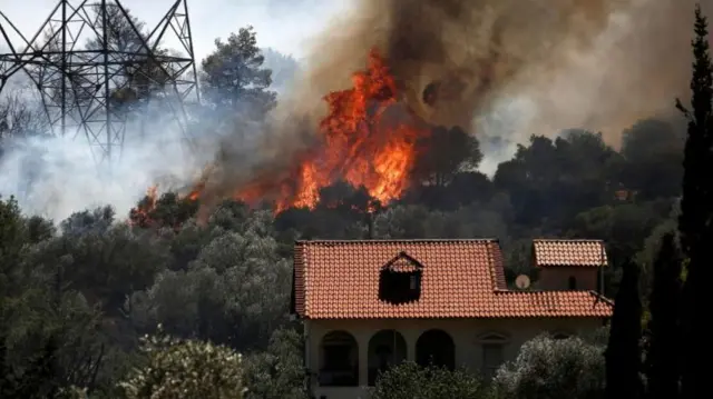 Fire burning near house in Kouvaras