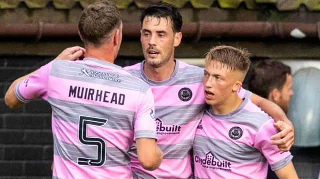 Brian Graham, centre, is hugged by team-mates after levelling the scoring