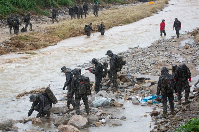 South Korean marines conduct a search operation at the site of a landslide caused by heavy rains in Yecheon-gun, Gyeongsangbuk-do province, South Korea, 18 July 2023