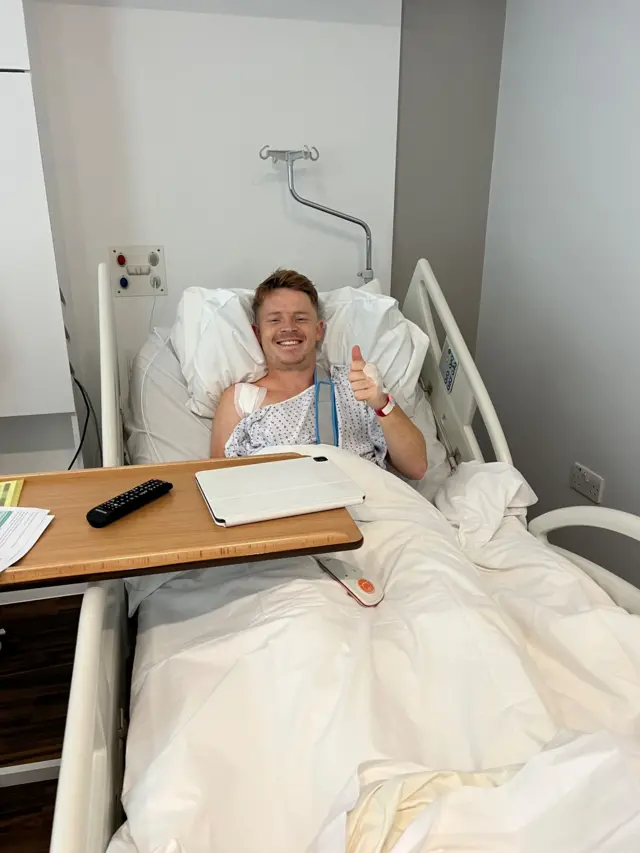 England batter Ollie Pope gives a thumbs up from his hospital bed after shoulder surgery