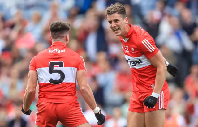 Conor Doherty celebrates scoring his sides first goal with Shane McGuigan