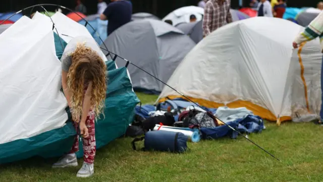 People setting up tents while camping out for Wimbledon tickets