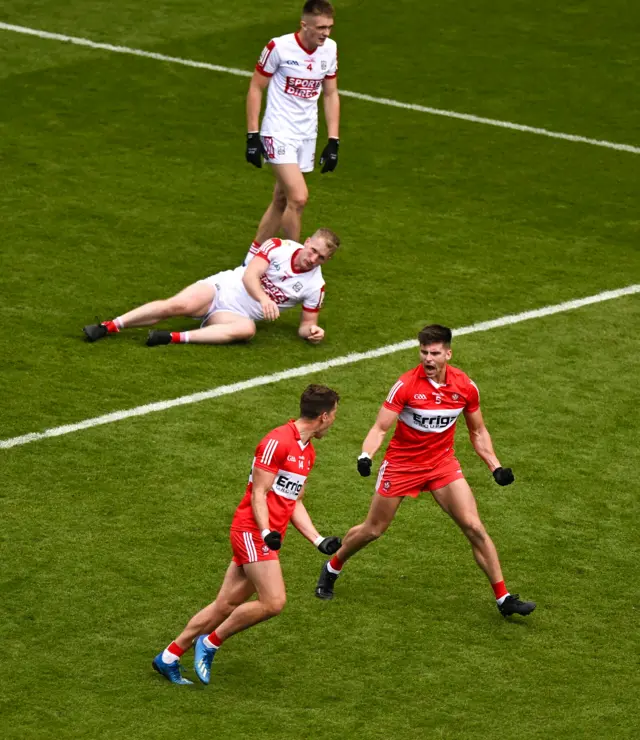 Conor Doherty of Derry, right, celebrates with teammate Shane McGuigan after scoring