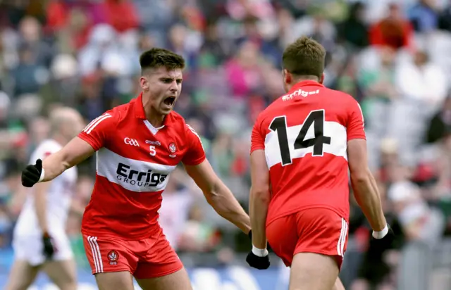 Conor Doherty celebrates after scoring a goal with Shane McGuigan