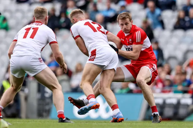 Brendan Rogers battling for possession with Killian O' Hanlon