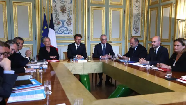 French President Emmanuel Macron (c) attends a government emergency meeting at the emergency crisis center of the Interior Ministry in Paris, France, 02 July 2023