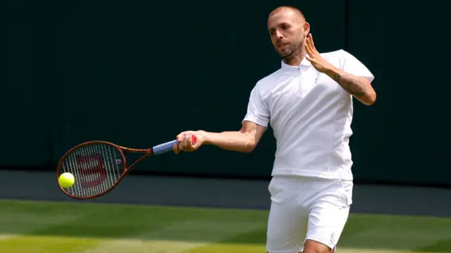 Dan Evans plays a forehand shot