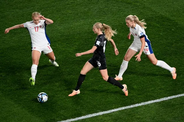 New Zealand forward Hand evades Norway defenders.