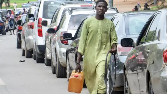 A person carrying a jerrycan of petrol