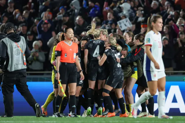 New Zealand players celebrate in front of their fans.