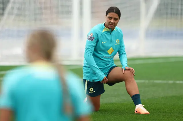 Sam Kerr stretches in Australia's training session.