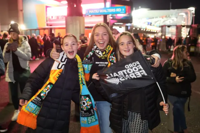 New Zealand fans smile for the camera at the opening game.