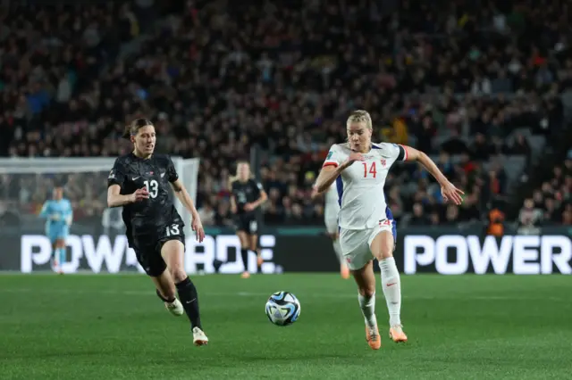 Ada Hegerberg attempts to take on Rebekah Stott.