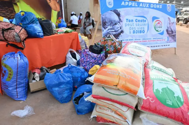 This photograph taken on October 5, 2022 shows bags of rice, clothes and multiple goods collected by local charity associations for the residents of Djibo, where a supply convoy was attacked