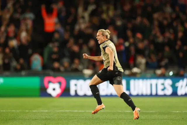 Matchwinner Hannah Wilkinson charges onto the field in delight.