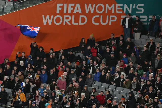 New Zealand fans celebrate their side's momentous win in the stands.