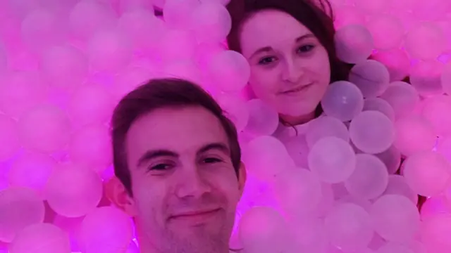 A couple surrounded by pink bubbles