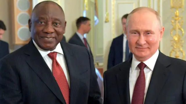 Russian President Vladimir Putin shakes hands with South African President Cyril Ramaphosa