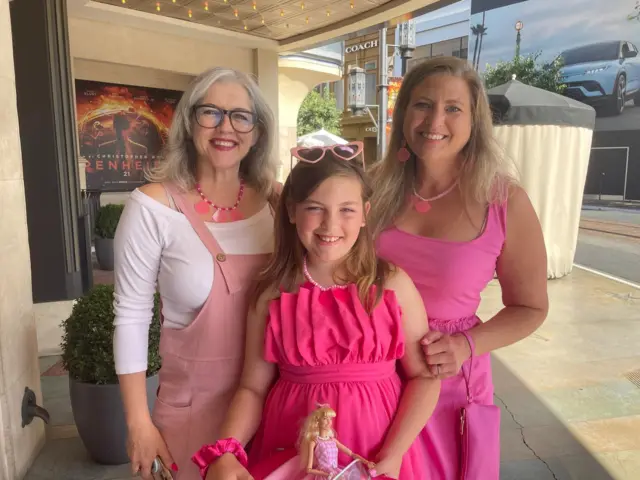 Barbie fan Ruby (centre) with her Barbie doll in hand